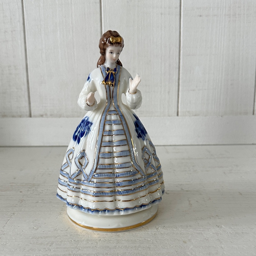 Vintage Royal Crown Derby Porcelain Figurine with Blue and Gold Accents.